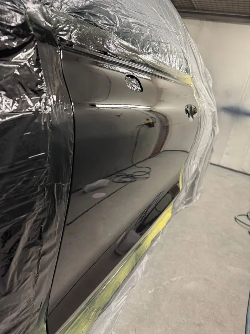Car side panel with a deep gloss finish in the booth
